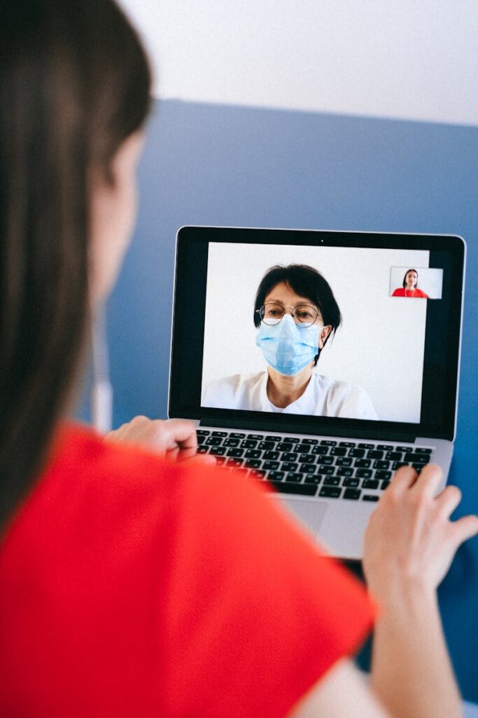 A telemedicine session with a doctor on a laptop screen, highlighting health consultation during COVID-19.