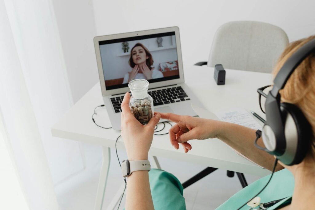 A medical professional consulting a patient online via video call for remote healthcare services.