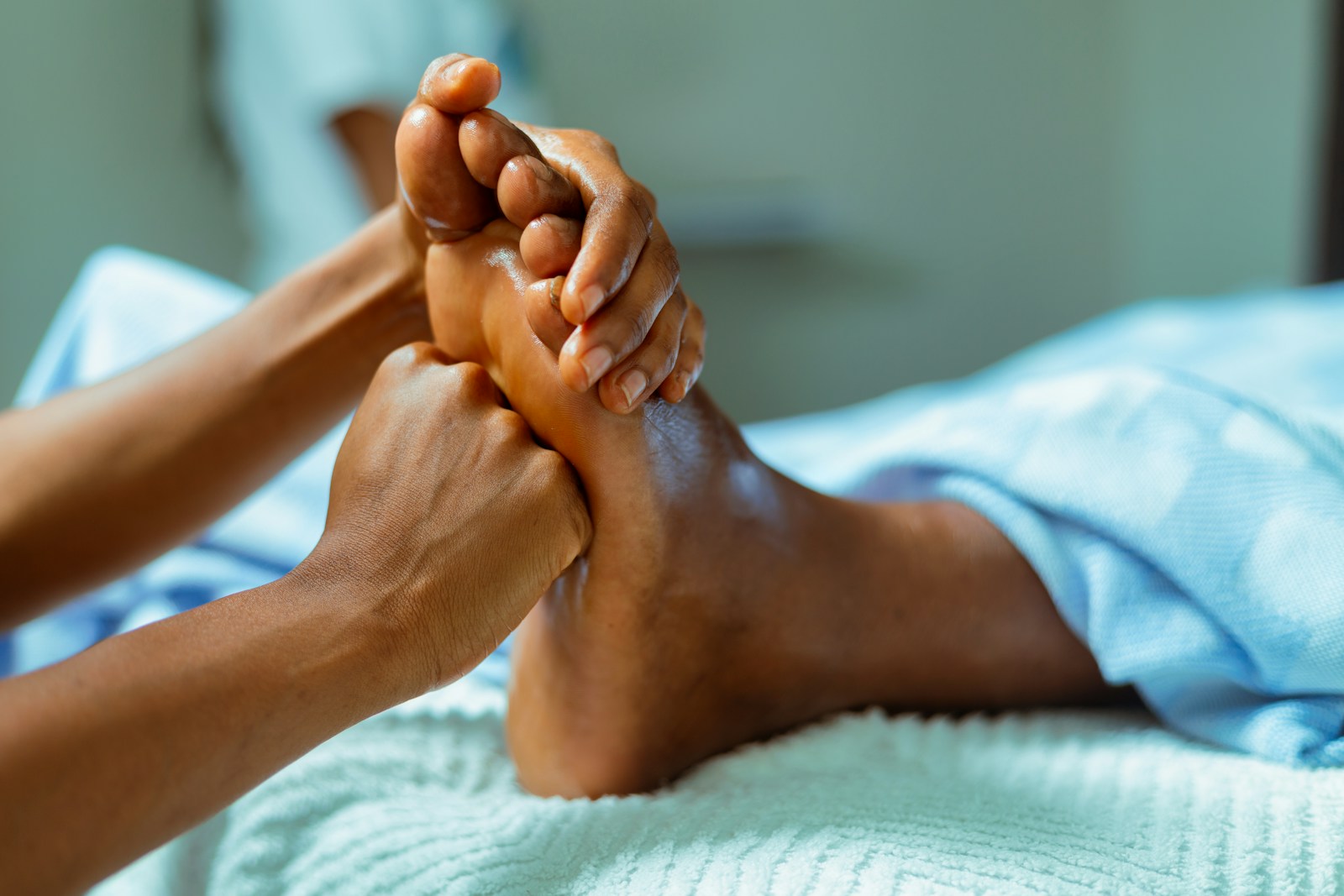 a person laying in a bed with their feet up